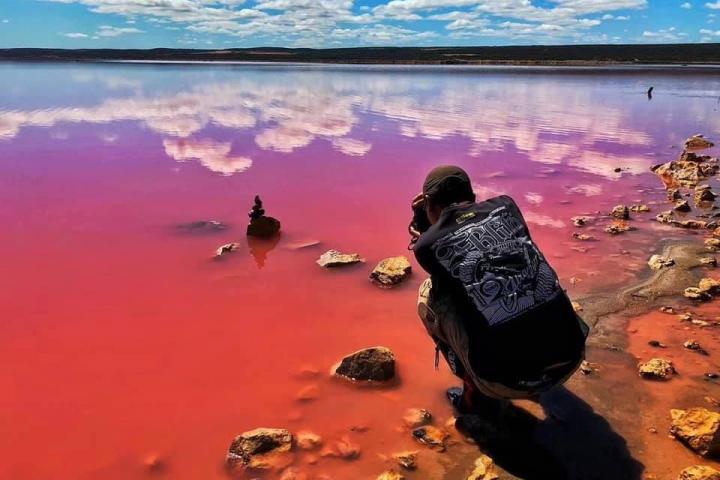 Guy taking a photo on Pink Lake