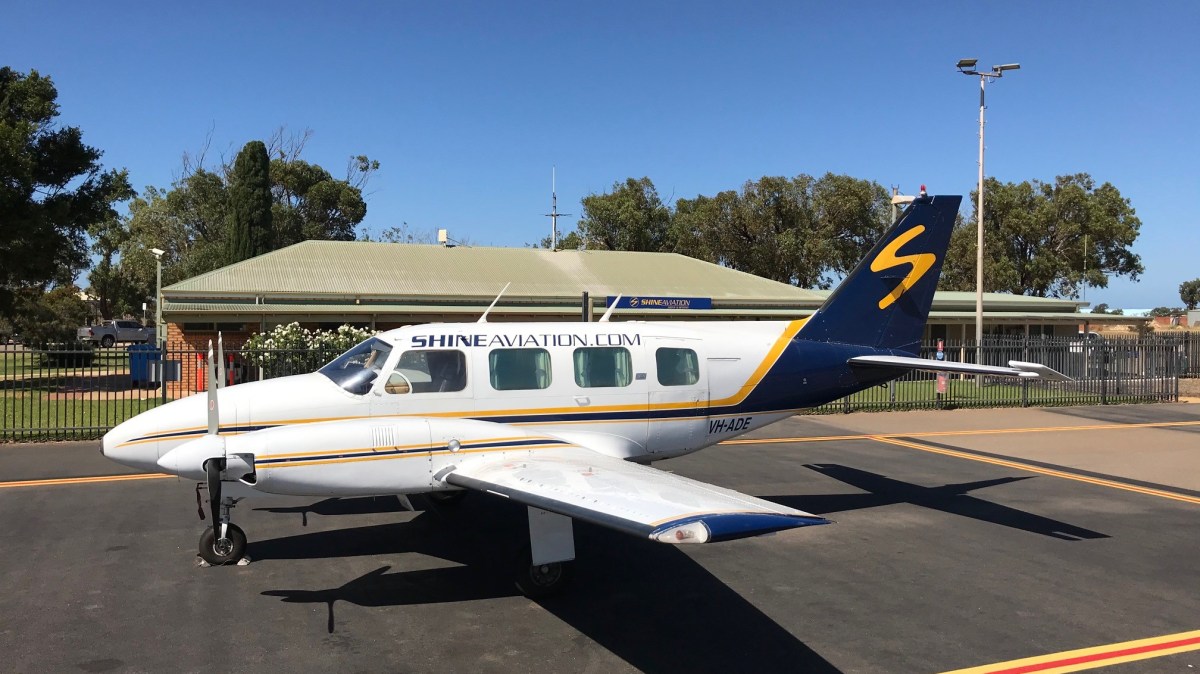 ADE Website a small plane parked on the side of a road