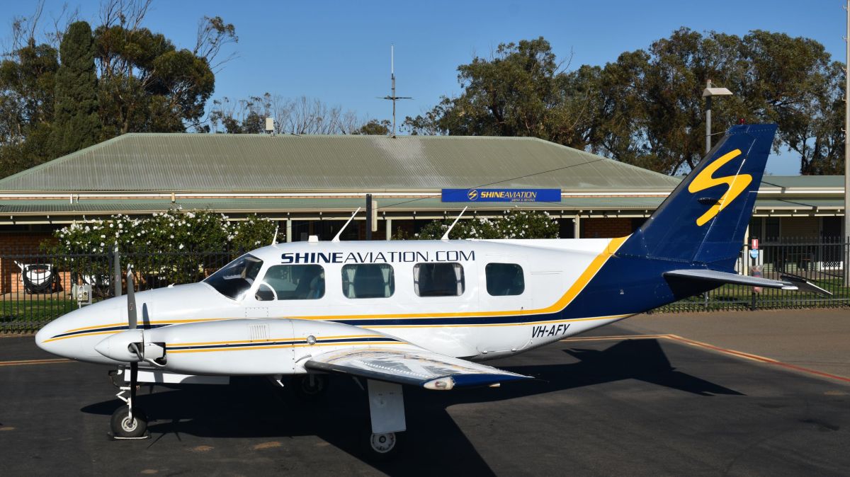 VH-AFY a small airplane is parked on the side of a road