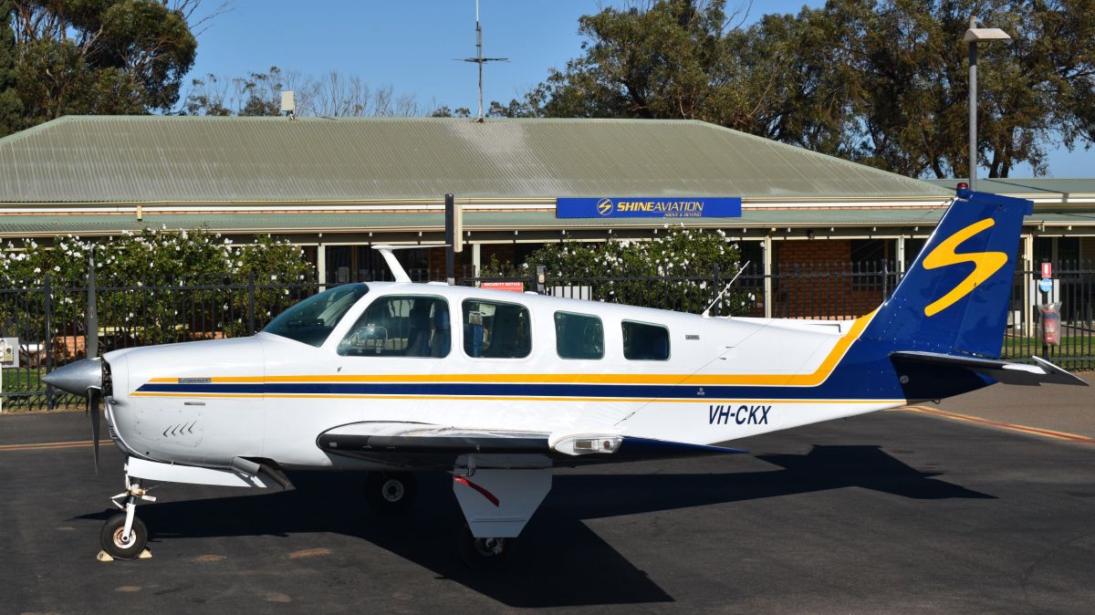 VH-CKX a small airplane is parked on the side of a road