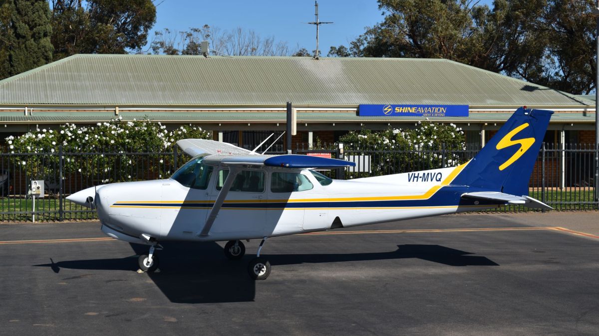 VH-MVQ a small airplane is parked on the side of a road