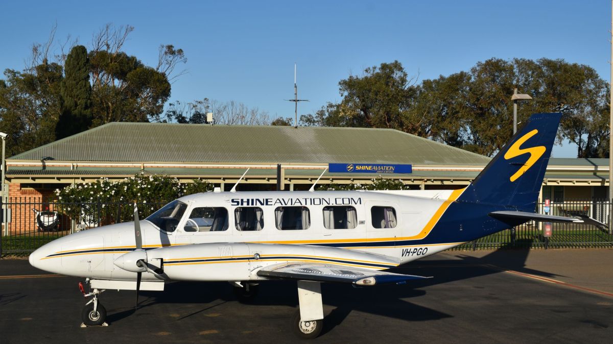 VH-PGO a small airplane is parked on the side of a road