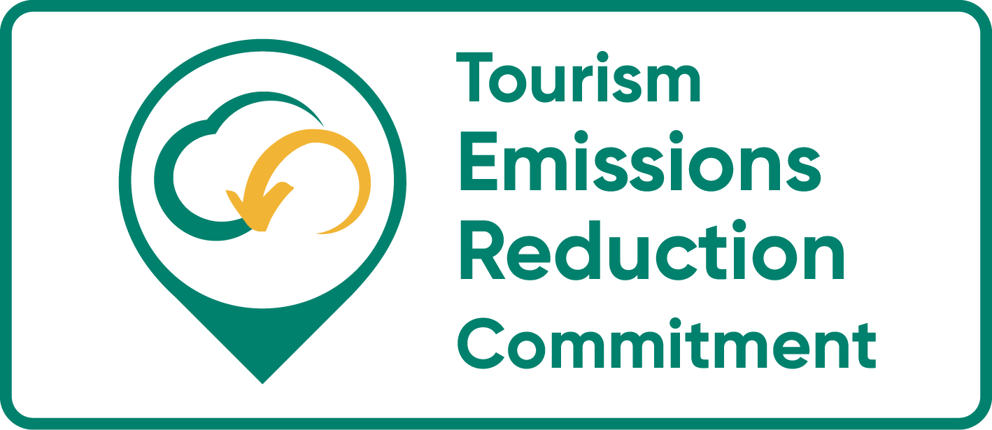 Tourism Emissions Reduction Commitment logo with cloud and arrow icon.